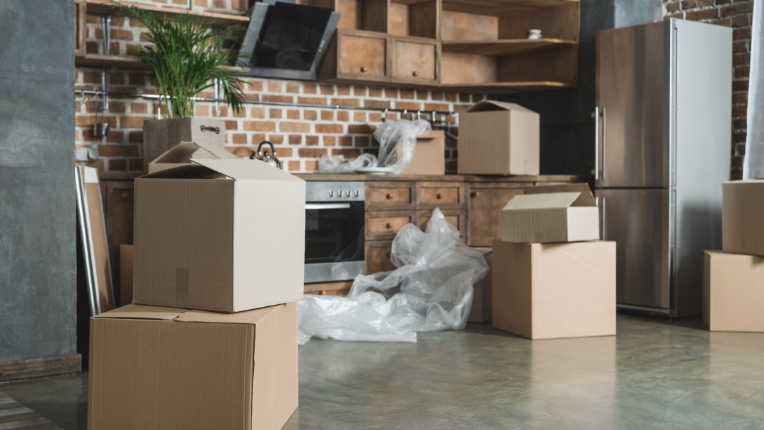 cardboard-boxes-in-empty-kitchen-during-relocation.jpg